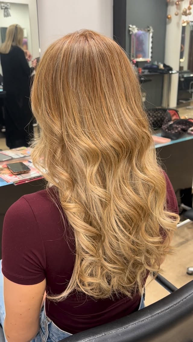 Warm blonde hair styled in soft waves at Brash Hair Design